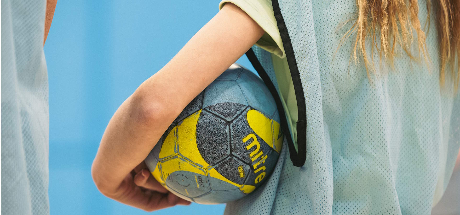 A close up of a person holding a football