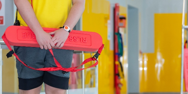 A lifeguard holding a float